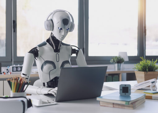 A humanoid robot works in an office on a laptop to listening Music in  Headphone, showcasing the utility of automation in repetitive and tedious tasks.